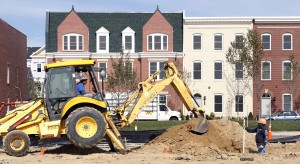 Workers prepare new housing lot at a construction site in Alexandria